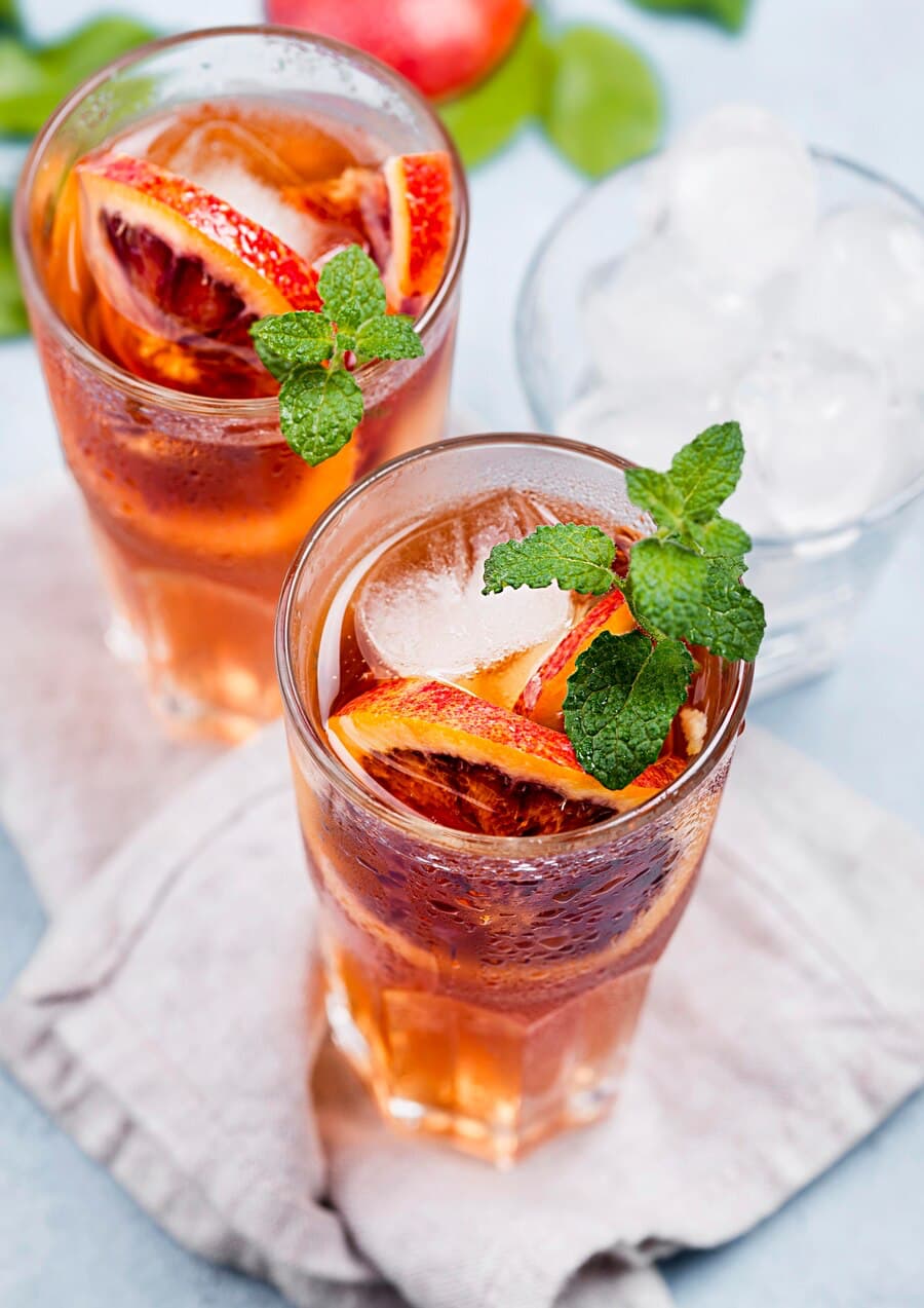 Glasses with Aromatic Fruit Ice Tea - Macro of Grapefruits