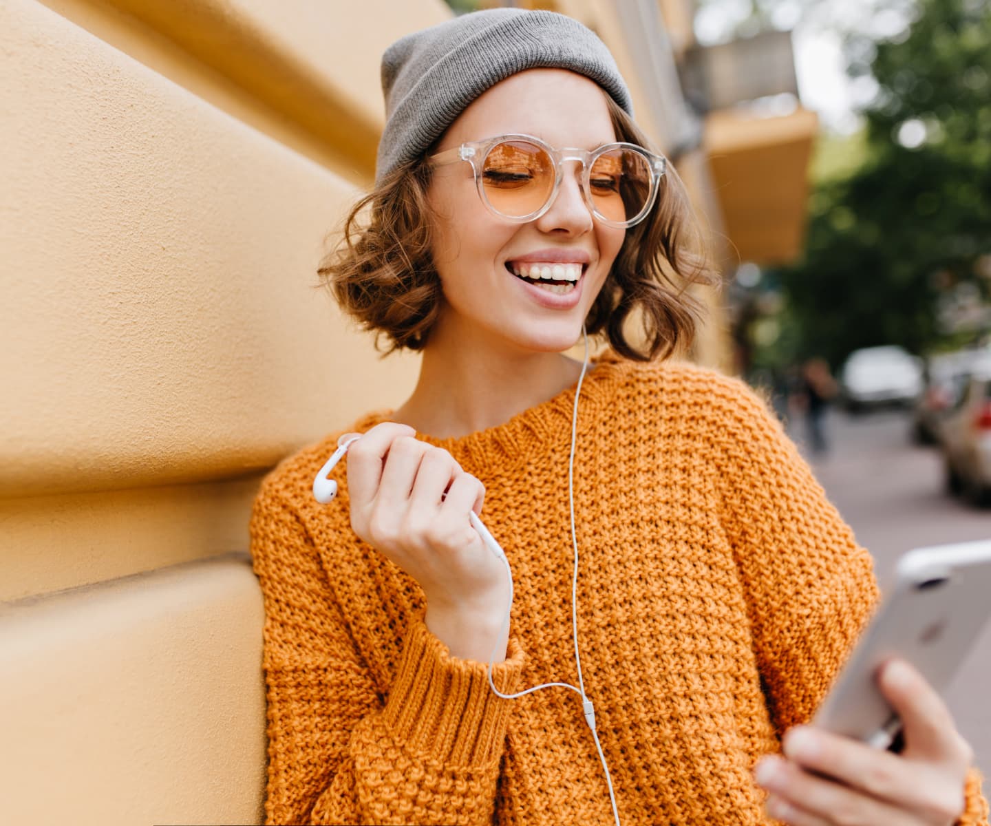 Smiling girl with headphones engaged in Online Course or Content